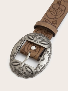 Close-up of vintage brown leather belt with embossed rose patterns and carved silver buckle