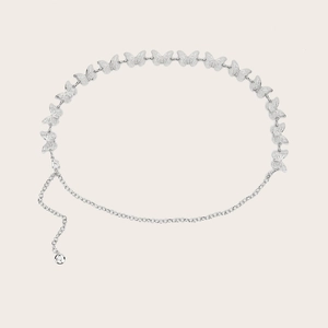 Close-up of silver metal waist chain featuring hollow butterfly links and lobster clasp