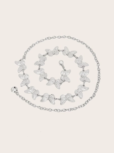 Macro detail of silver butterfly metal waist chain with hollow engraved textures