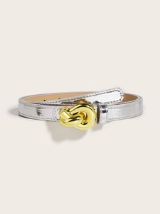 Detailed view of a slim silver belt featuring a stylish gold metal knot buckle design