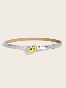 Close-up of shiny silver mirror belt with a golden metallic knot buckle design