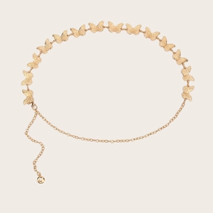 Detailed close-up of golden metal butterfly waist chain with embossed texture and clasp