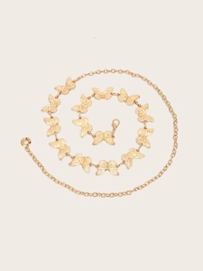Macro detail of golden butterfly chain belt with textured metal links and lobster clasp