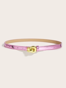 Detail of a thin pink metallic belt with a knot-style golden buckle for women's fashion