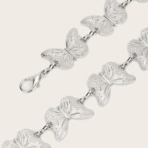 Vintage silver butterfly chain belt with textured metal charms and lobster clasp closure
