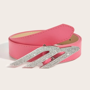 Detailed view of pink faux leather belt featuring a crystal encrusted winged buckle
