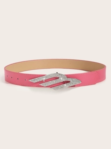 Detail of a bright pink belt featuring a vintage silver buckle with sparkling rhinestones