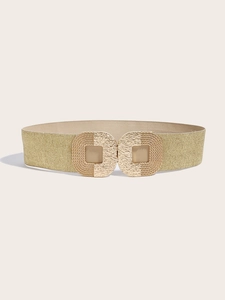 Close-up of golden elastic belt featuring hammer-textured square buckles and metallic weave