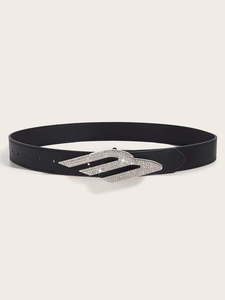 Detailed view of black leather belt with a silver rhinestone winged buckle and studs