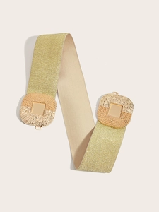 Detail of wide gold elastic waist belt with textured square buckle for dresses