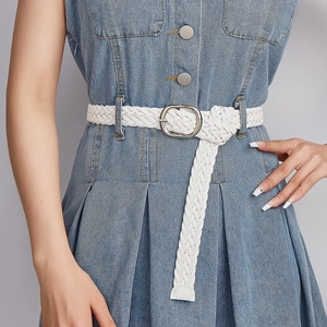 White woven leather belt for women with silver metal buckle on a blue denim dress
