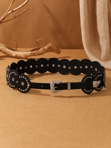 Detailed view of Western retro belt with silver rivets and floral engraved buckle