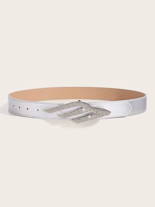 Detail of silver metallic belt featuring a rhinestone-encrusted flame style buckle