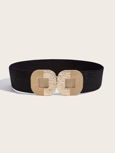 Close-up of a wide elastic belt with a hammered golden geometric buckle and black strap