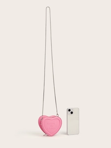 Pink heart-shaped mini crossbody bag with silver chain strap shown next to a smartphone