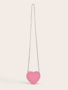 Close-up of heart-shaped pink mini crossbody bag with silver chain and zipper detail