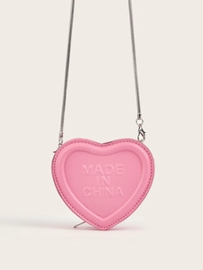 Detail of pink heart mini bag featuring textured faux leather and silver snake chain strap