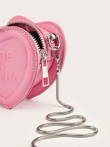 Close-up of pink heart-shaped mini leather bag with silver chain and metal zipper details
