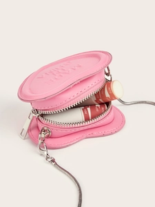 Pink heart-shaped mini purse showing interior capacity with lip gloss and chain detail