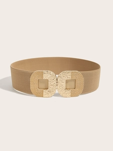 Detail of khaki wide elastic waist belt featuring a textured golden square buckle closure