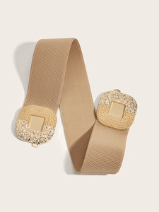 Close-up of beige elastic waist belt with large square textured golden metal buckles