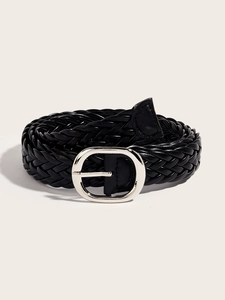 Detail view of black woven belt with silver oval buckle on a clean cream background