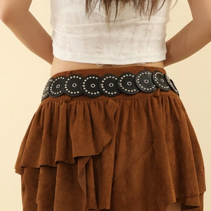 Vintage PU leather belt with metallic rivets paired with a brown suede layered mini skirt