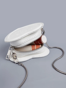 Detailed view of heart-shaped white PU leather mini bag with silver snake chain