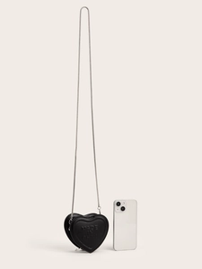 Mini black heart-shaped bag with silver chain strap shown next to phone for size reference