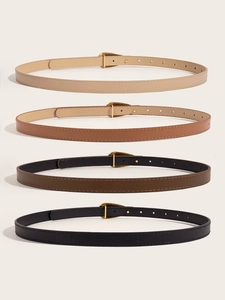 Vertical flat lay of four slim faux leather belts in black, brown, tan, and cream colors