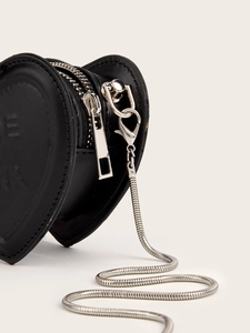 Detail view of heart-shaped black leather mini pouch with silver zipper and snake chain