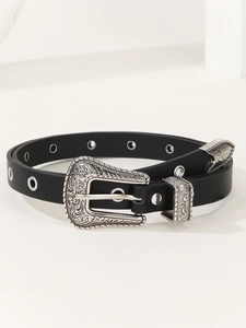 Dettaglio di una cintura Western vintage con fibbia floreale argento e occhielli
