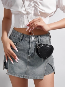 Close-up of heart-shaped black PU leather mini chain bag with textured logo detail