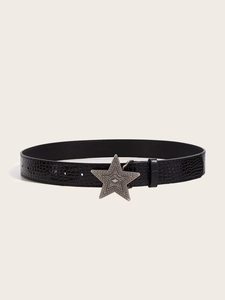 Detail of black faux crocodile skin belt with vintage star shaped metallic buckle