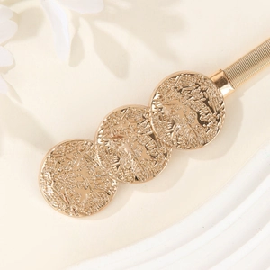 Elegant gold elastic metal spring waist belt featuring three textured embossed medallions