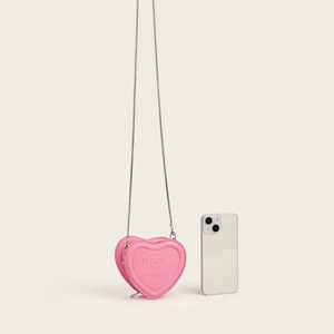 Pink heart-shaped mini crossbody bag with metal chain strap and phone size comparison