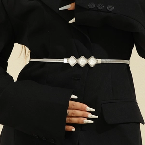 Elegant silver spring belt with three diamond accents styled on a black blazer for women