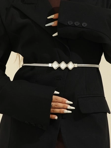 Detail of silver elastic metal belt with three rhombus-shaped buckles and pearl inlay