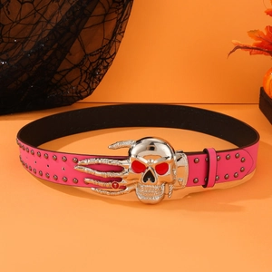 Pink punk faux leather belt with large silver skull buckle and metal studs on orange backdrop