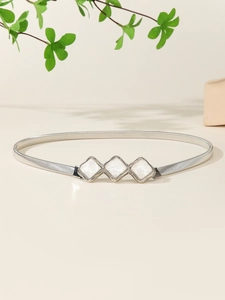 Detail of silver elastic spring belt with diamond-shaped buckles and white marble inlay