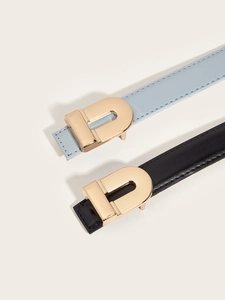 Detailed view of leather belts with elegant golden D-shaped buckles and fine stitching