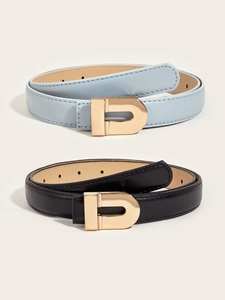 Detail of slim leather belts in blue and black with polished gold D-shaped buckles