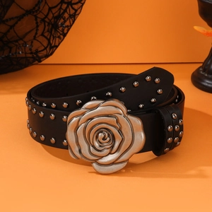 Punk style black leather belt with large silver rose buckle and studs on orange background