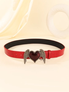 Detail of burgundy crocodile-embossed belt with silver-toned winged heart buckle