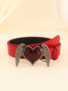 Macro detail of wine red crocodile texture belt with silver wings and heart buckle
