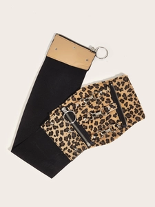 Detail view of punk style elastic belt with leopard print, zippers, and metal rings