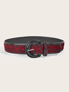 Detail of red leopard print belt with faux fur texture and black oval buckle design