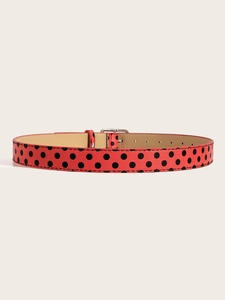 Detail showing vintage Y2K red belt with black polka dots and silver metal buckle