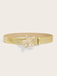 Macro shot of gold women belt with snake texture and large flower buckle detail