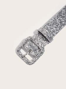 Close-up of women's slim silver glitter belt with a sparkling square buckle detail